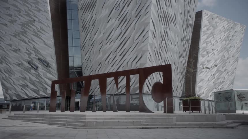 There is a large logo sign in front of the buildings