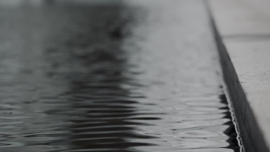 Close up of water meeting cement edge