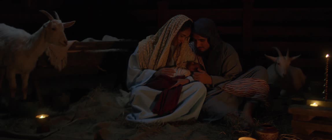 Actors portraying joseph and mary and baby jesus in the manger