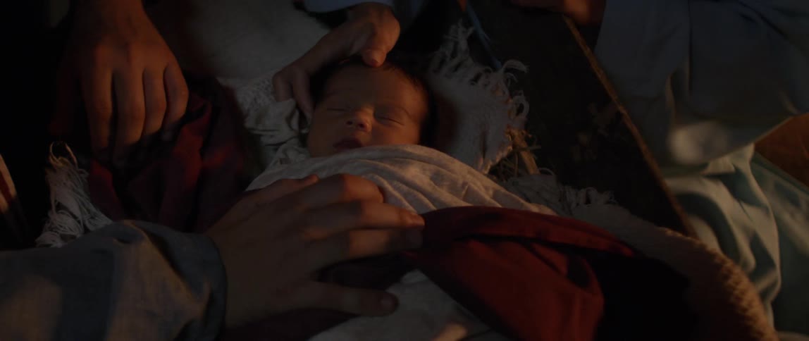 A white person strokes a white babys head