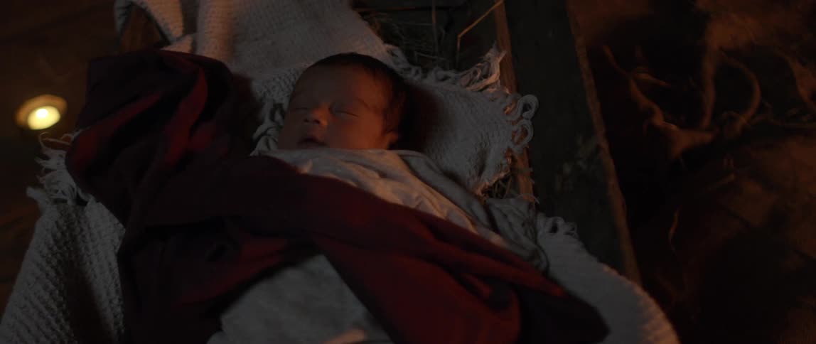 Baby sleeps peacefully next to the fire at night