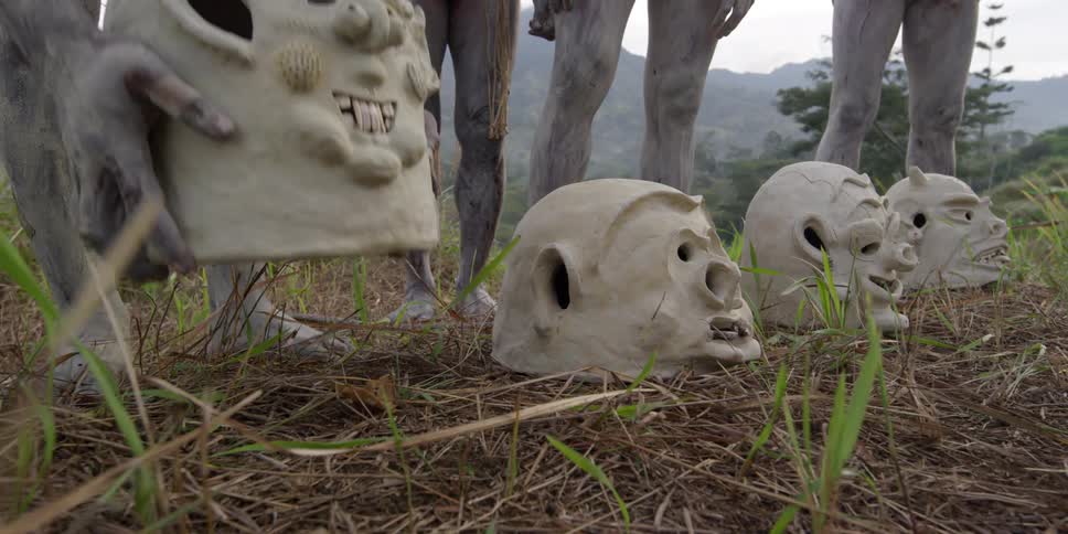 A person picks up a pottery helmet