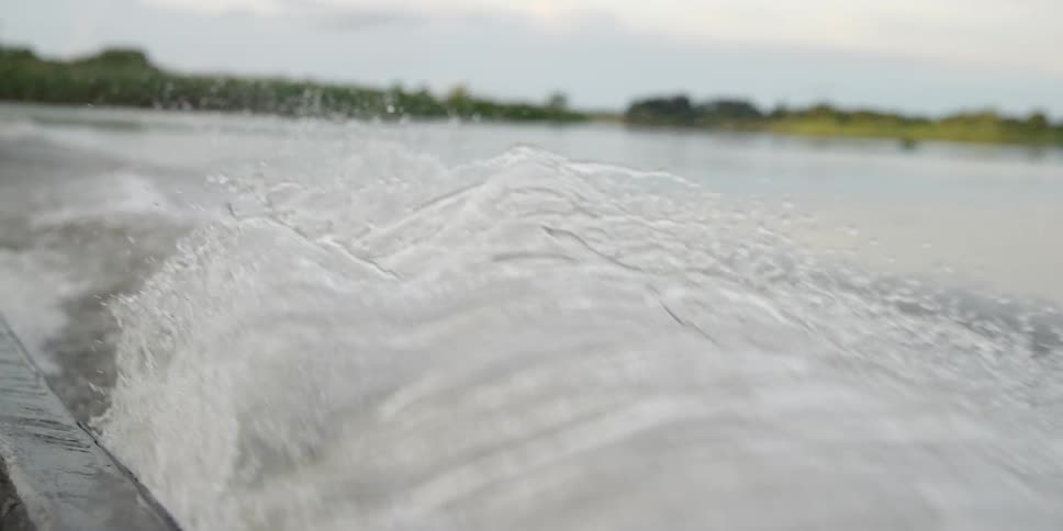 A boat churns up waves on a lake