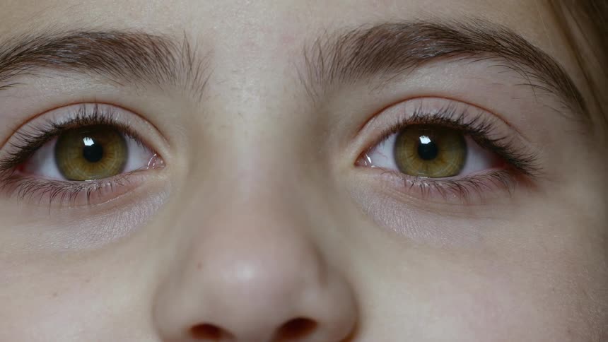 A child with brown eyes staring and blinking