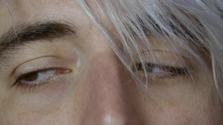 A person moving their eyes from side to side and then staring at the camera