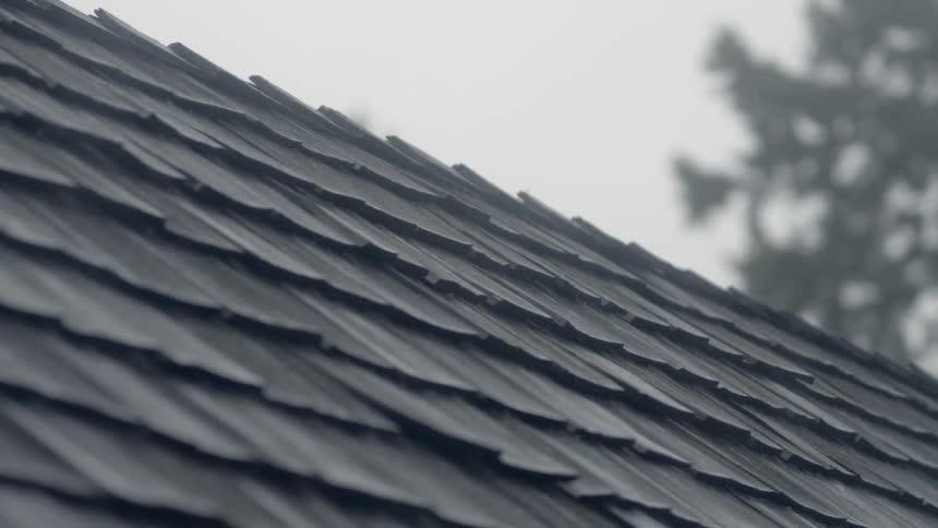 Wooden shingles on a roof in the rain