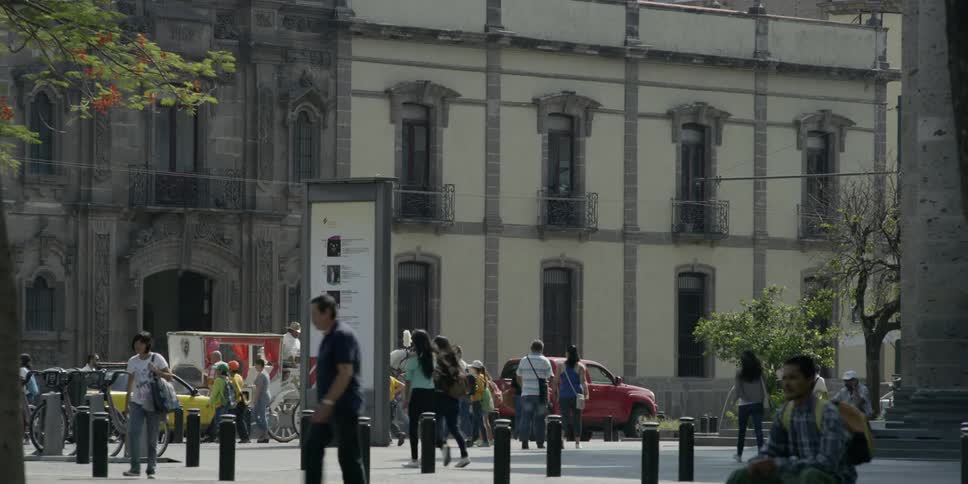 Hispanic people walk around a downtown area of a city