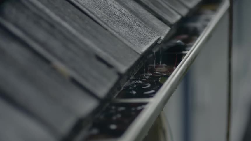 Rain drips off roof into gutter