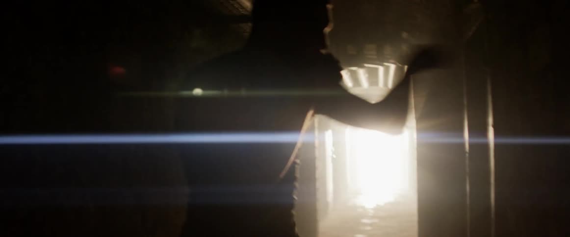 A male shadow boxing in a dark hallway