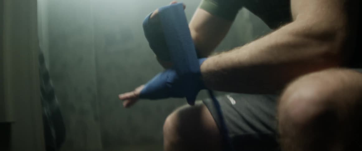 A man wraps his hand in tape