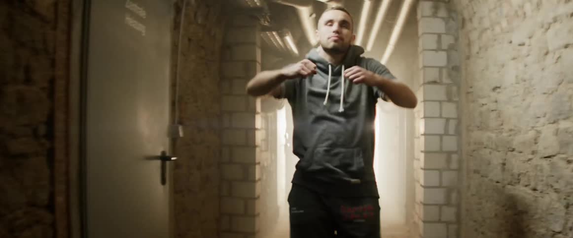 A man walking down a dimly lit hall