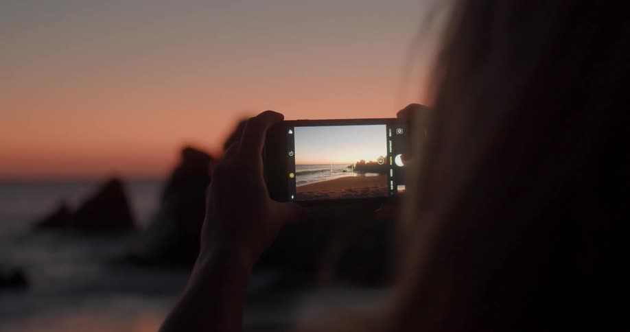 A woman is taking pictures on the horizon