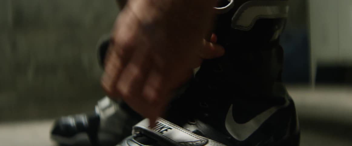 A person ties his athletic shoes