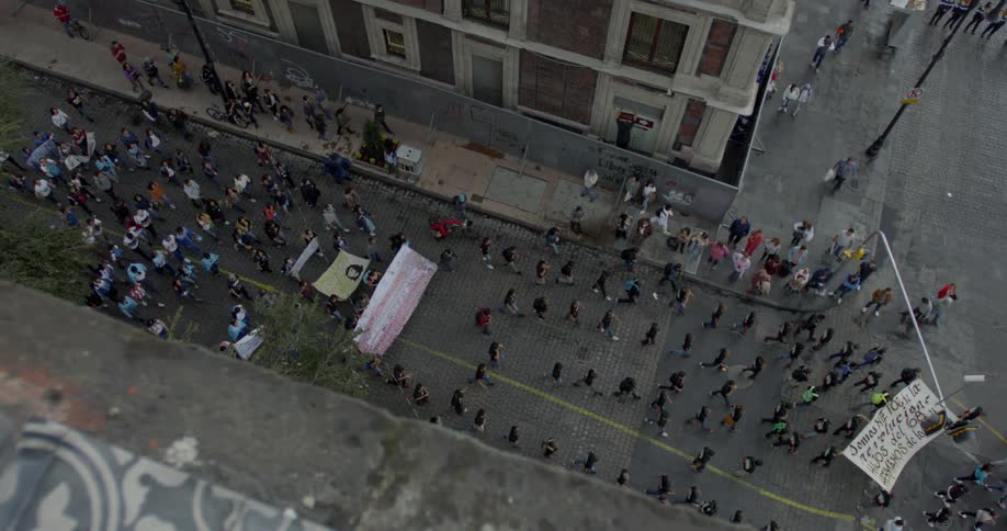 Protesters march carrying banners