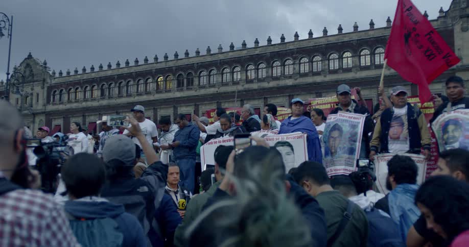 A group of people gather in front of a building