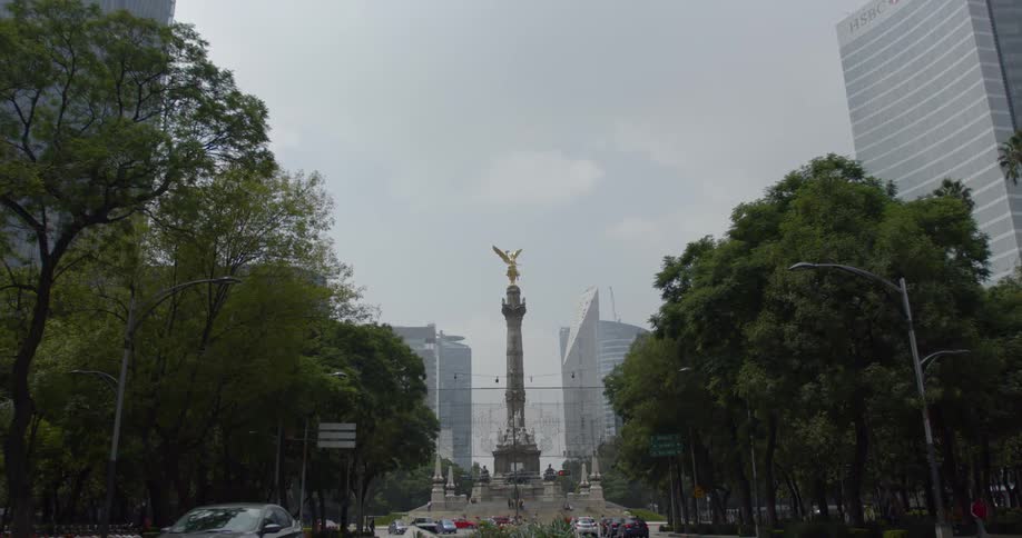 A shot of a statue in the middle of a city