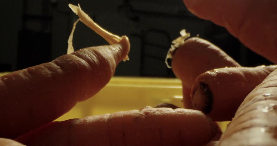 A bowl of unpeeled carrots