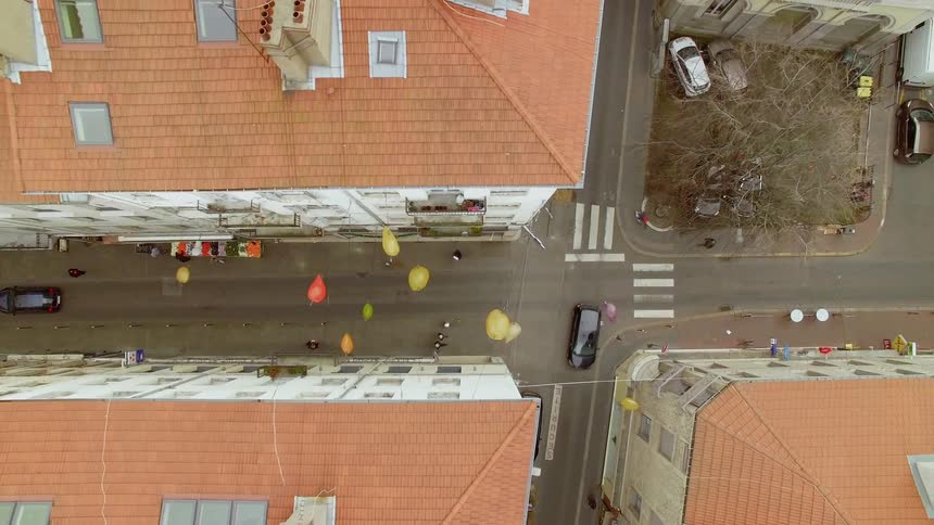 A town with buildings people and cars