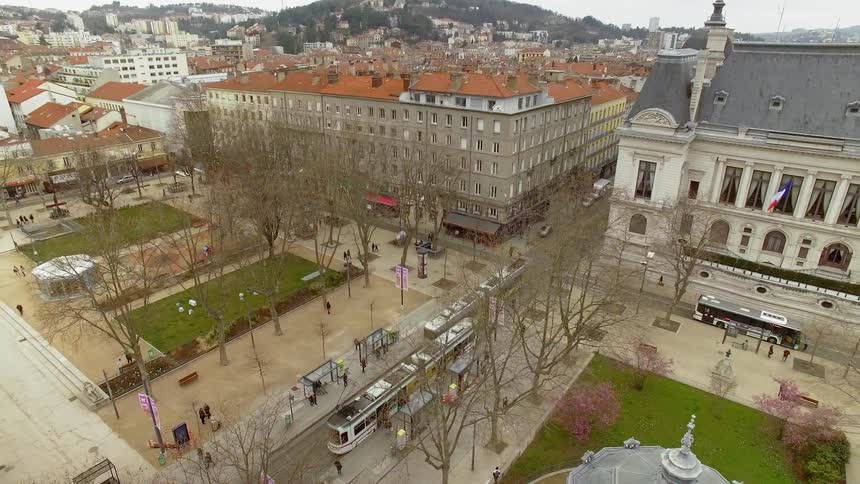 A town with people and a trolley at daytime