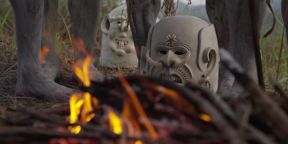 Mask at the base of peoples legs