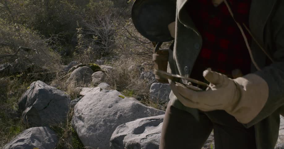 A man walking up a cliff