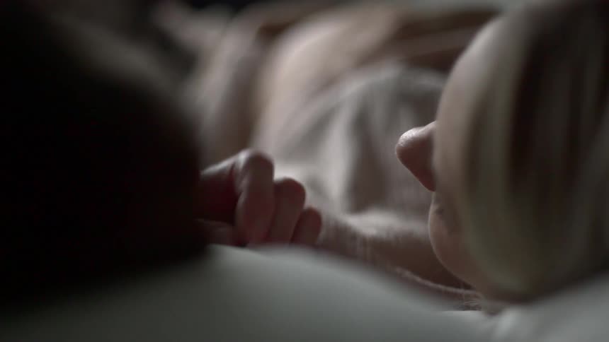 A woman and man laying in bed