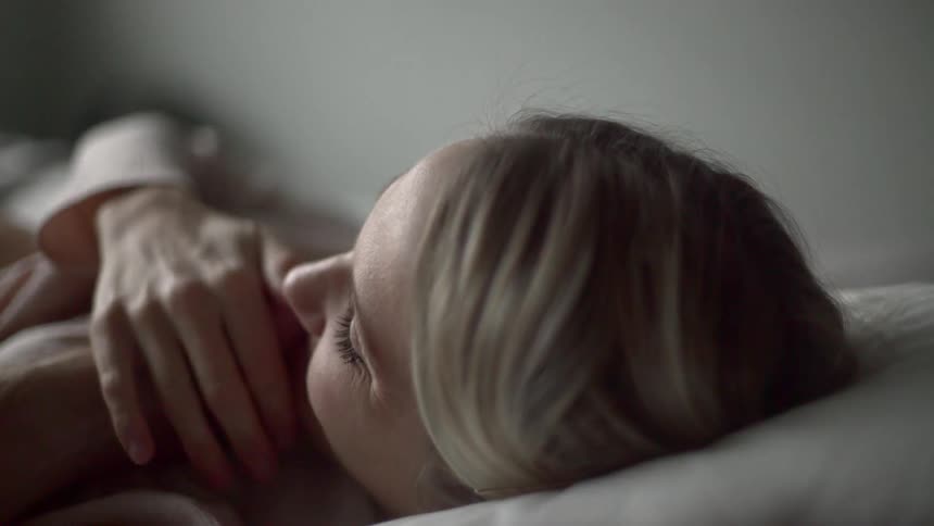 A woman getting her face touched by a man