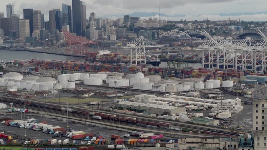 Storage tanks sit near a port in a large city