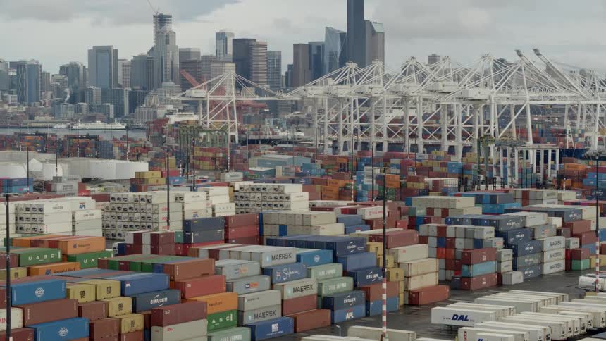 A loading dock with shipping containers and the city in the background