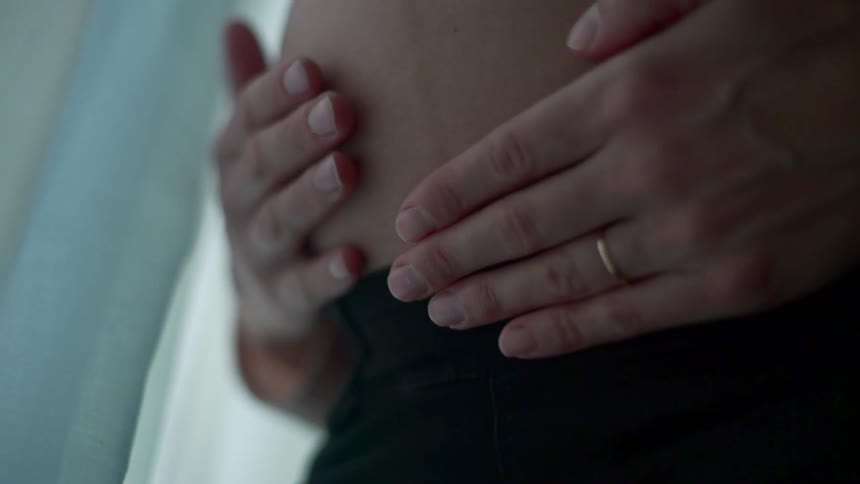 A pregnant woman holding her belly