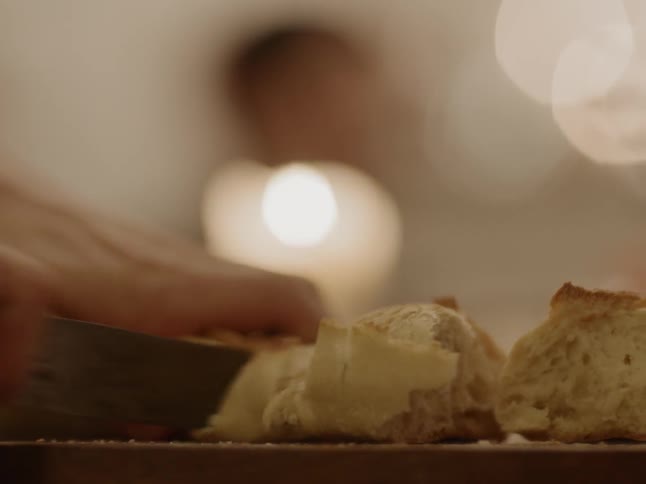 Bread being sliced with a knife
