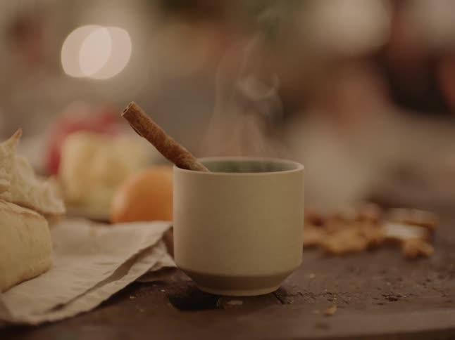 A person picks up a steaming beverage