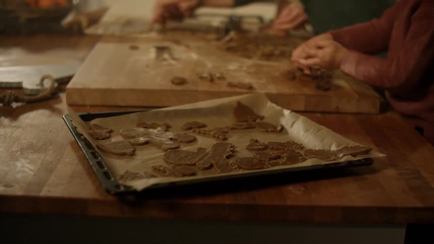 People form cookies on a cutting board