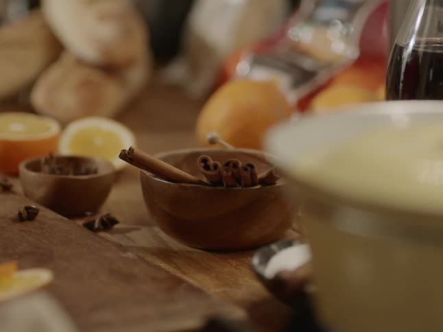 Cinnamon sticks sit in a bowl on a counter