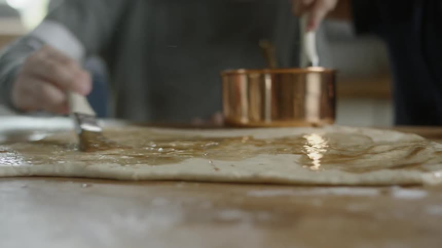 Two people are preparing food together