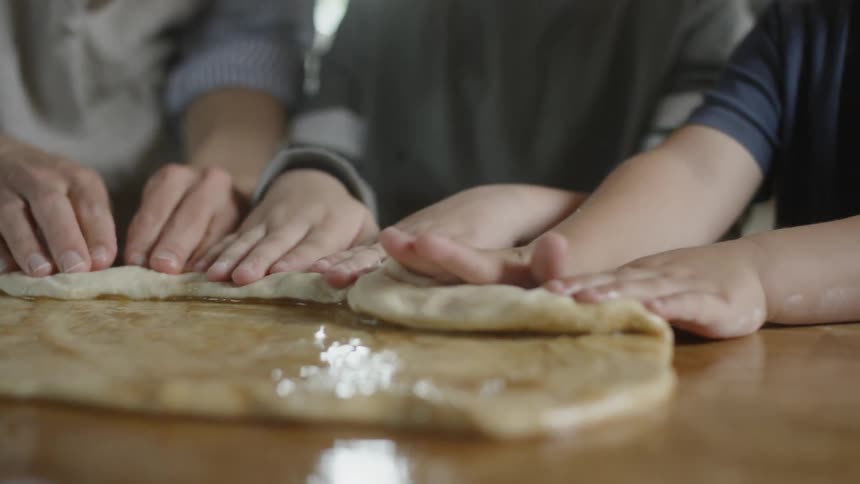 Children push dough on a counter