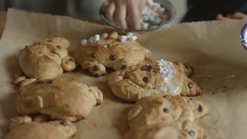 Children decorate baked desserts in a kitchen
