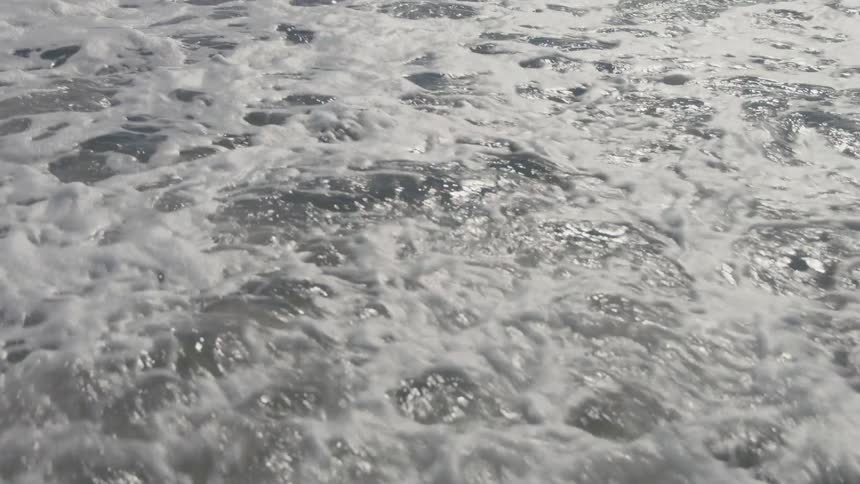Waves crashing and making foam