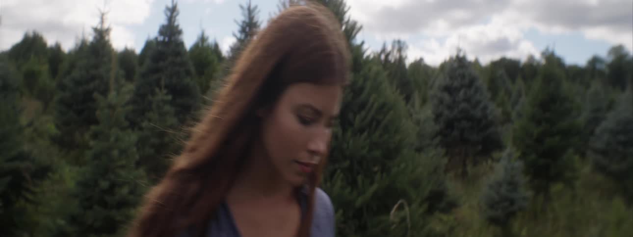 Woman walking outside in a wooded area