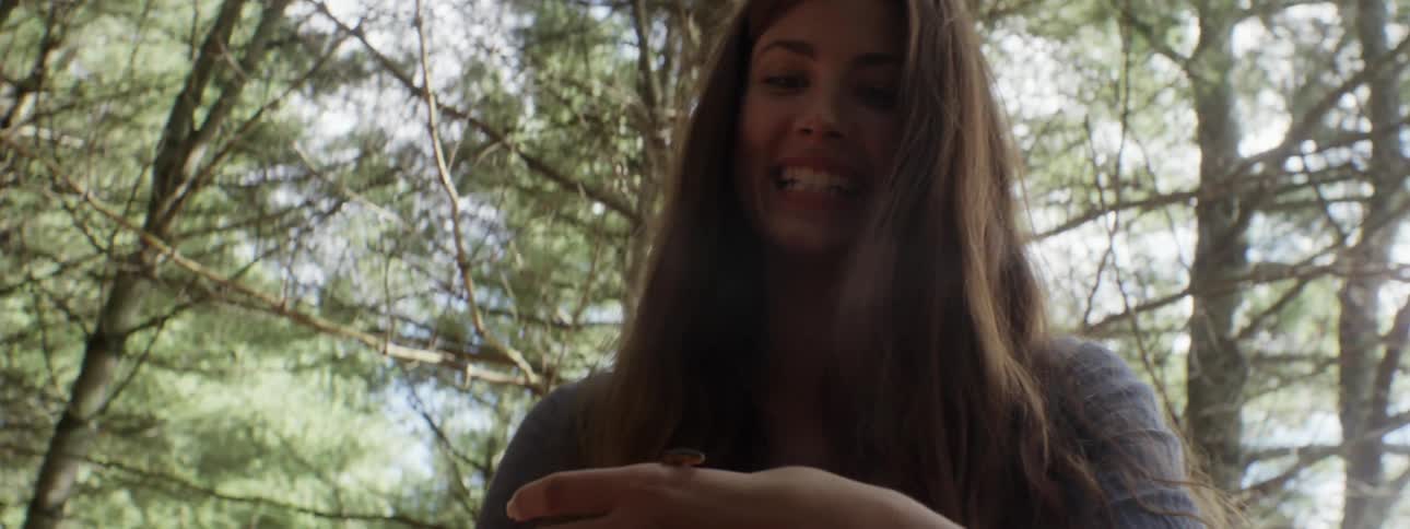 A woman holding an insect