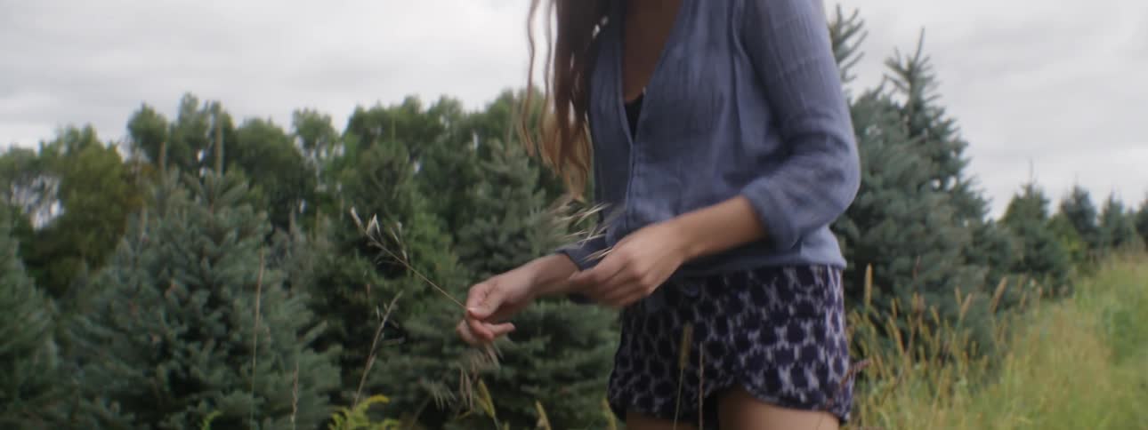Woman picking grass in a field