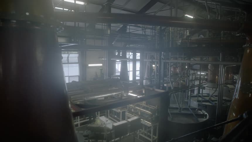 A whiskey distillery factory filled with pipes and equipment