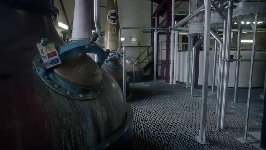 Machinery stands in a distillery in a warehouse