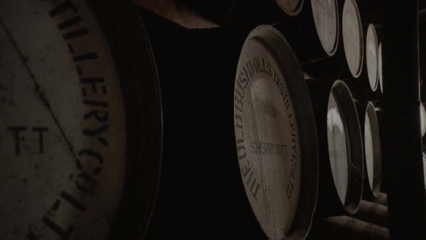 Wooden barrels sit on shelves