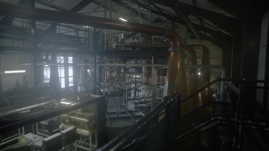 Pipes and equipment fill a large distillery