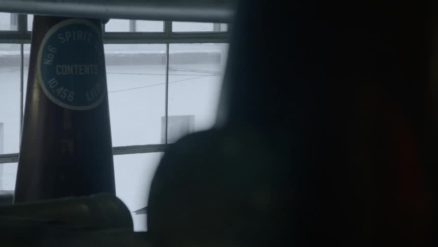 A person stands in the dark warehouse