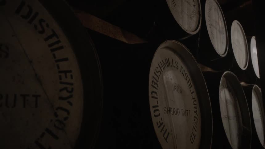 Wooden barrels sit on shelves