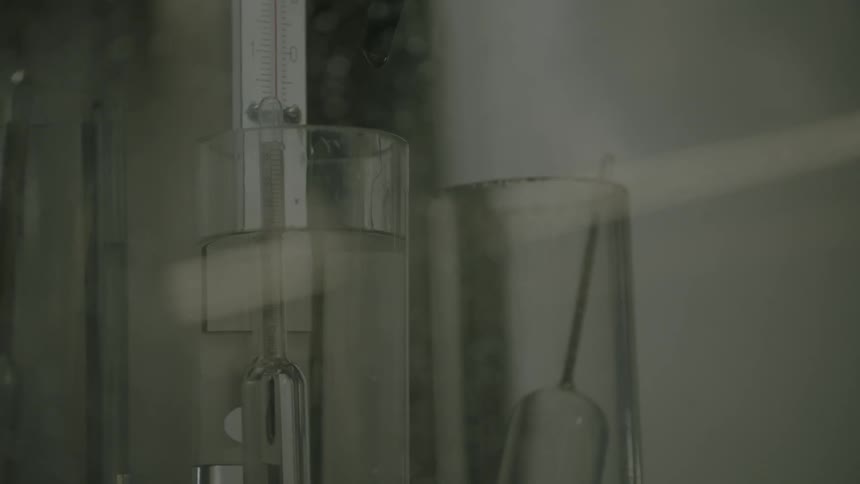 A beaker of liquid slowly rising to the top