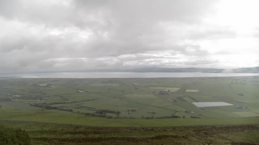 Fields in a valley near a lake