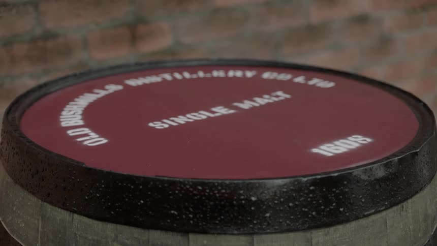 A barrel with a red lid on it sitting in a room